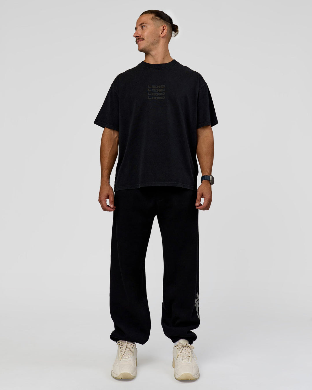 Man wearing Static Grit Baggy Track Pant - Black-Alloy | Model:Jaiden | Size:M