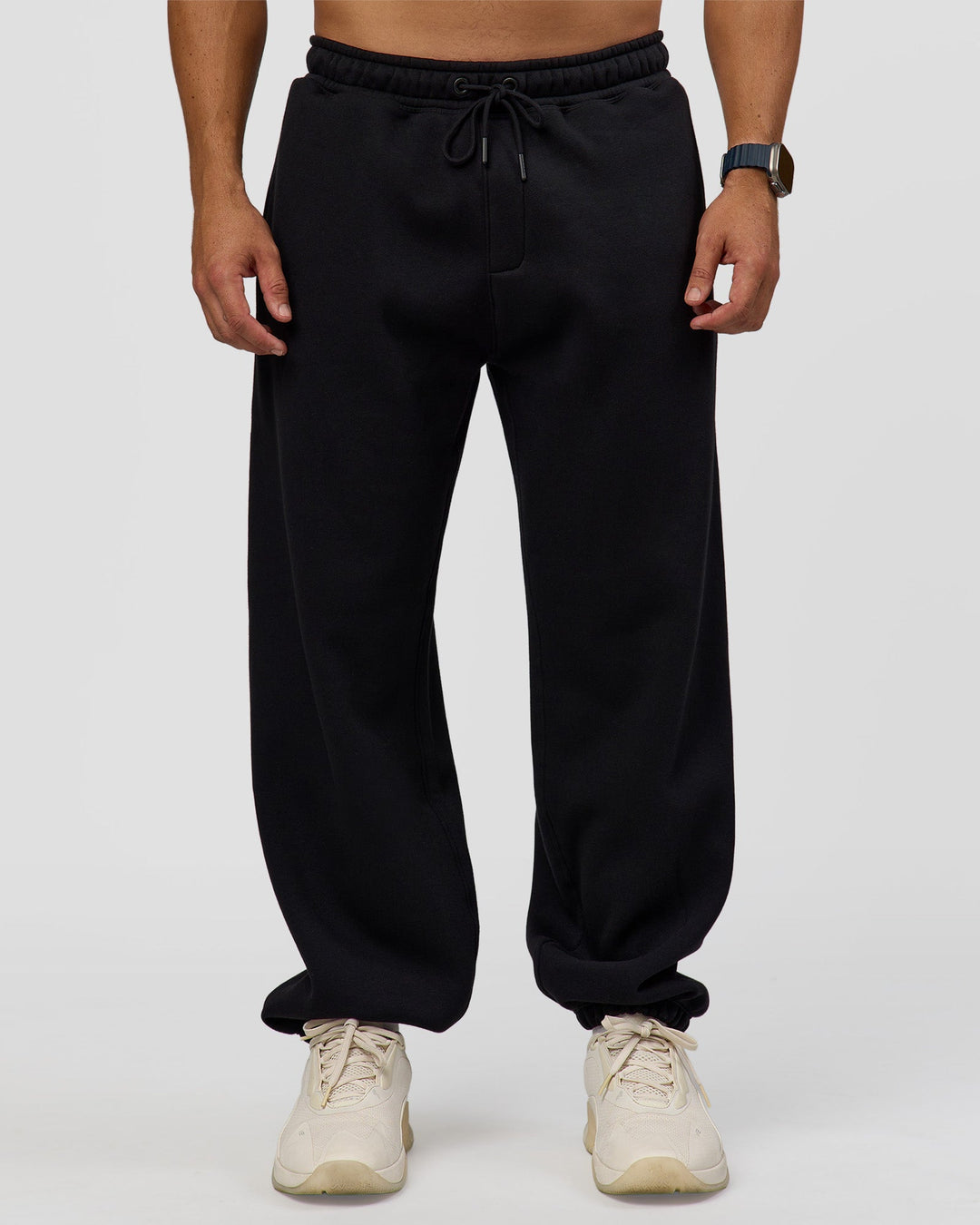 Man wearing Static Grit Baggy Track Pant - Black-Alloy | Model:Jaiden | Size:M