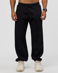 Man wearing Static Grit Baggy Track Pant - Black-Alloy | Model:Jaiden | Size:M