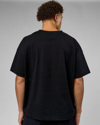 Man wearing 86 V-Neck Oversized Tee - Black-Black | Model:Leandro | Size:M