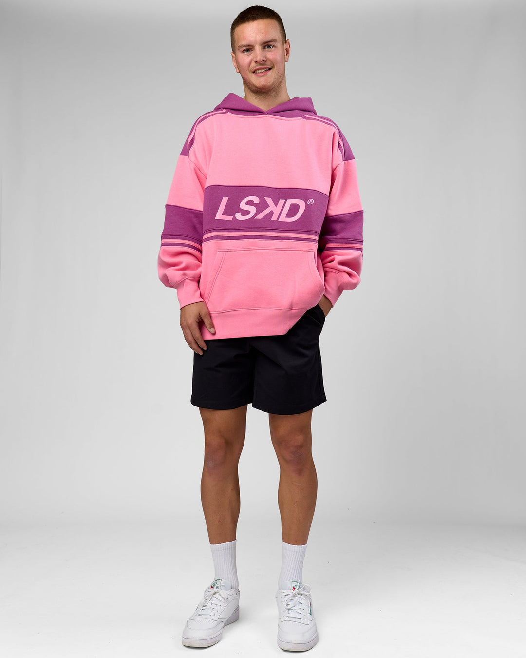 Man wearing A-Team Oversized Hoodie - Candy Pink-Boysenberry | Model:Arran | Size:M