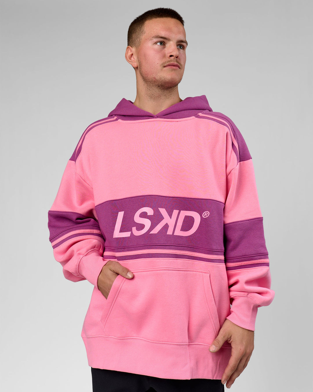Man wearing A-Team Oversized Hoodie - Candy Pink-Boysenberry | Model:Arran | Size:M