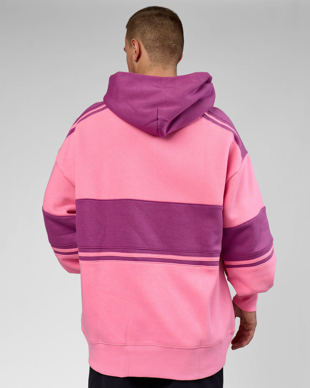 Man wearing A-Team Oversized Hoodie - Candy Pink-Boysenberry | Model:Arran | Size:M