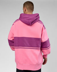 Man wearing A-Team Oversized Hoodie - Candy Pink-Boysenberry | Model:Arran | Size:M