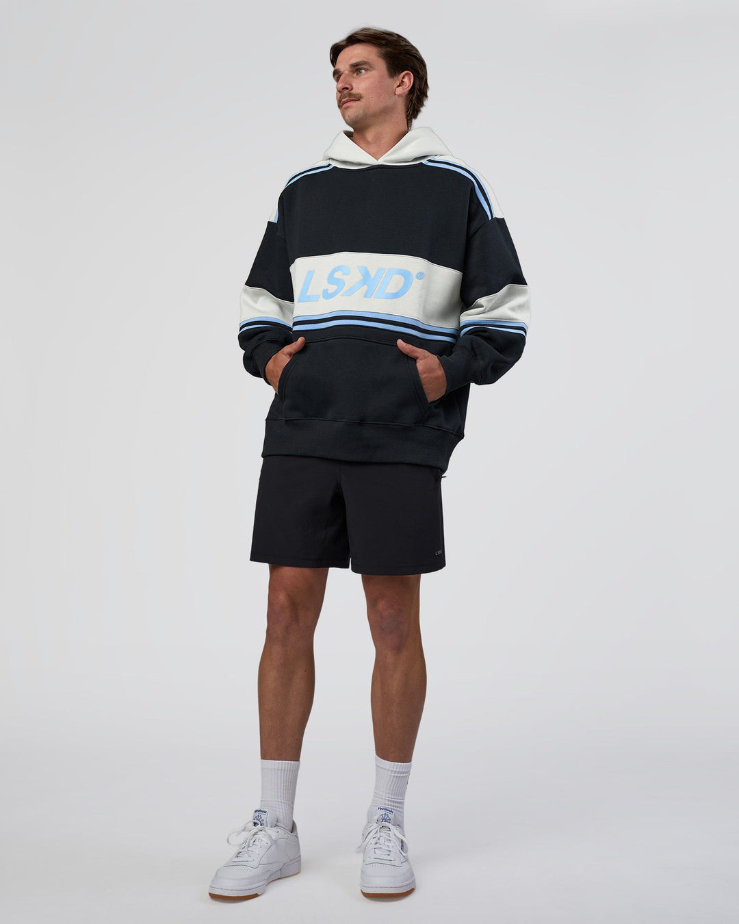 Man wearing A-Team Oversized Hoodie - Caviar-Open Air | Model:Konnor | Size:M