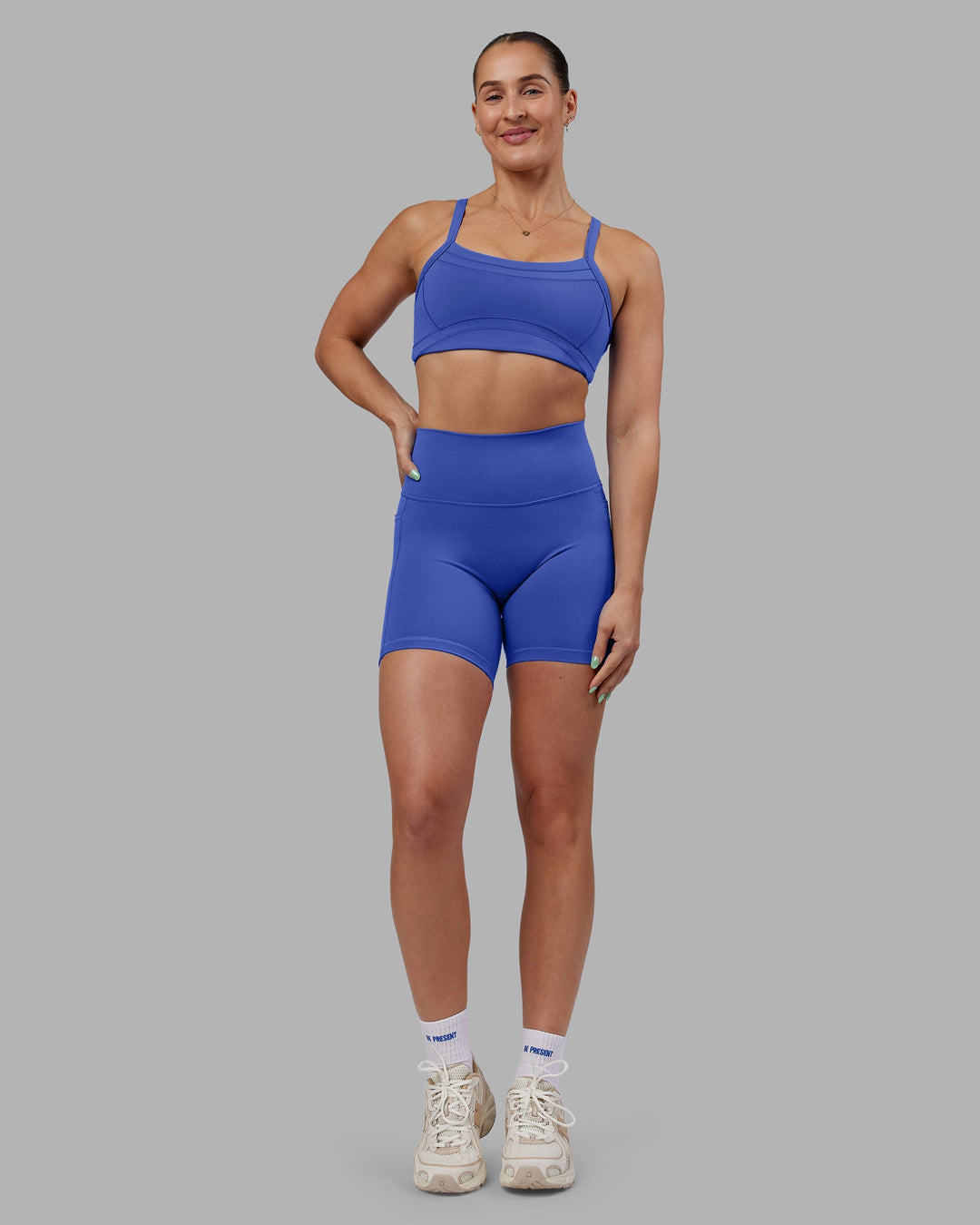 Woman wearing Abs Ignite Sports Bra - Power Cobalt | Model:Abbey | Size:M