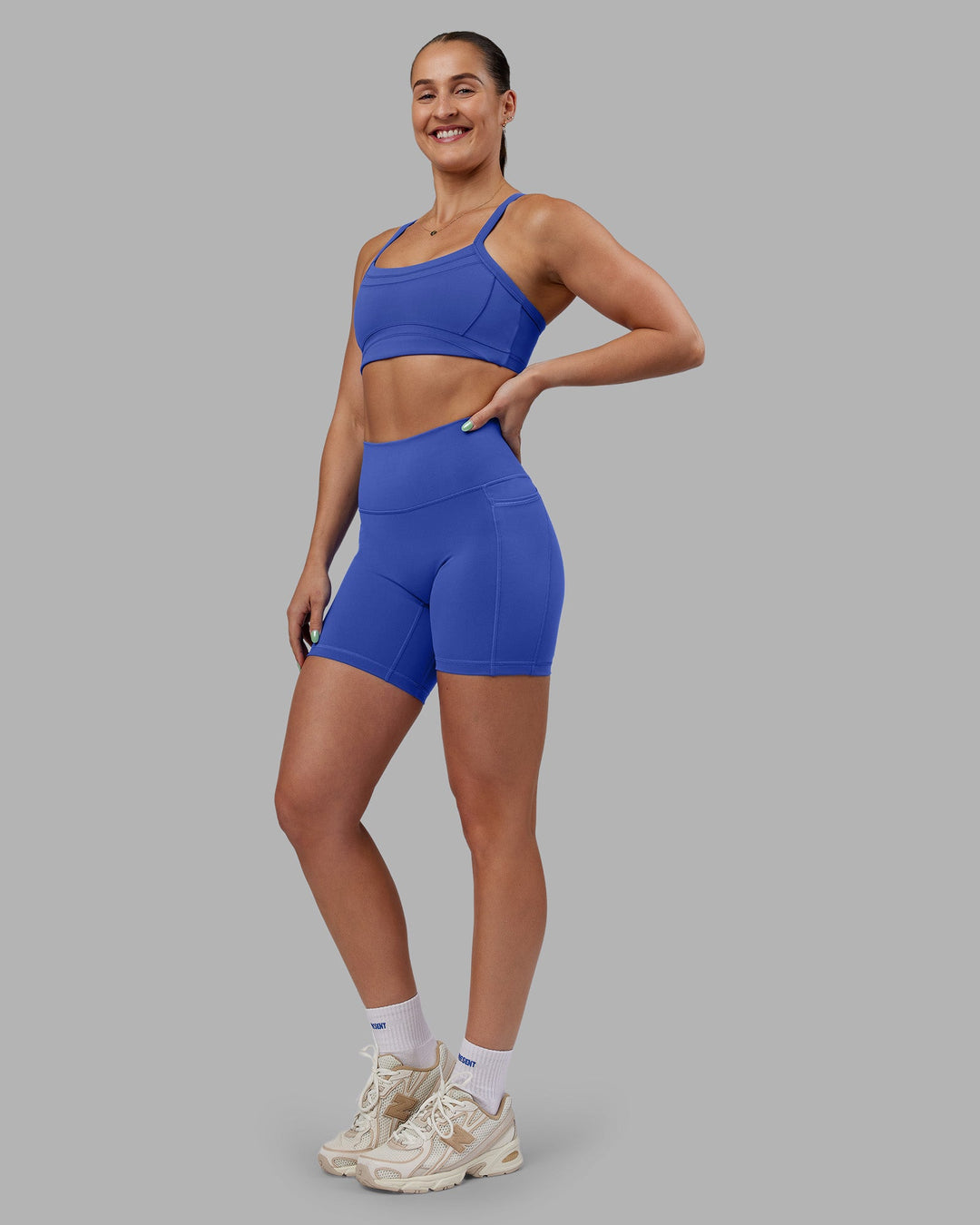 Woman wearing Abs Ignite Sports Bra - Power Cobalt | Model:Abbey | Size:M