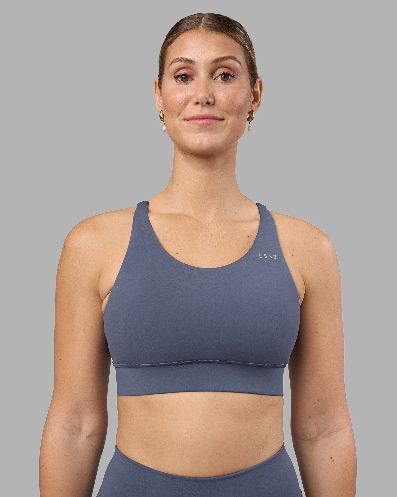 Woman wearing Accelerate Sports Bra - Night Shadow | Model:Amy | Size:M