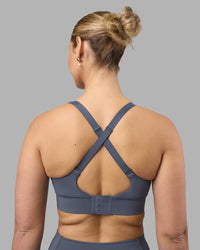 Woman wearing Accelerate Sports Bra - Night Shadow | Set:true | Angle:back | Model:Amy | Size:M