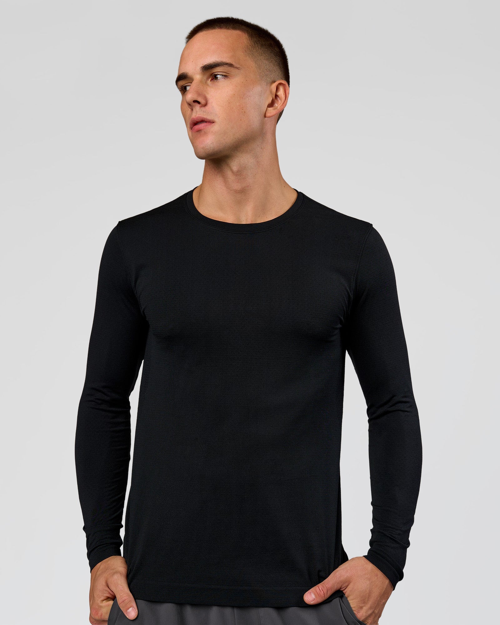Man wearing AeroFLX+ Seamless Long Sleeve Tee (Set in Sleeve) in Black/Black | Model:Albert | Size:M