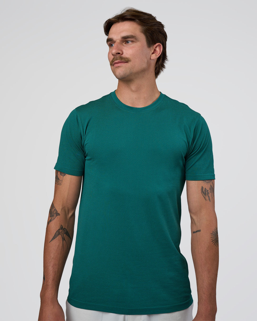 Man wearing AeroFLX+ Seamless Set In Tee - Teal/Teal | Model:Konnor | Size:M - view 1
