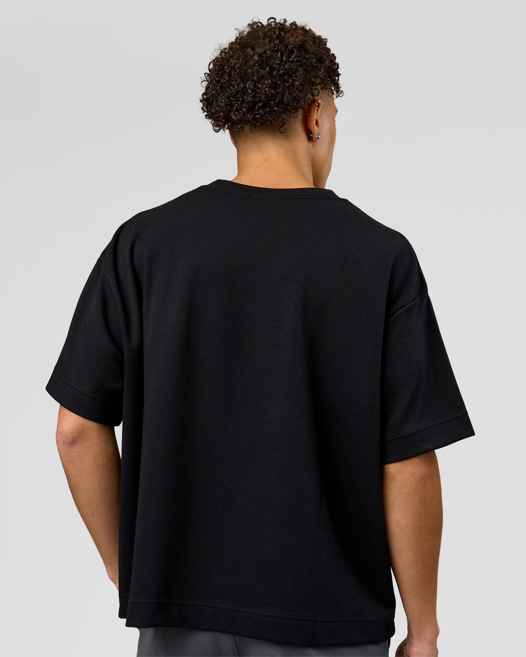 Man wearing AfterDark ZeroCrease Boxy Tee in Black | Model:Leandro | Size:M
