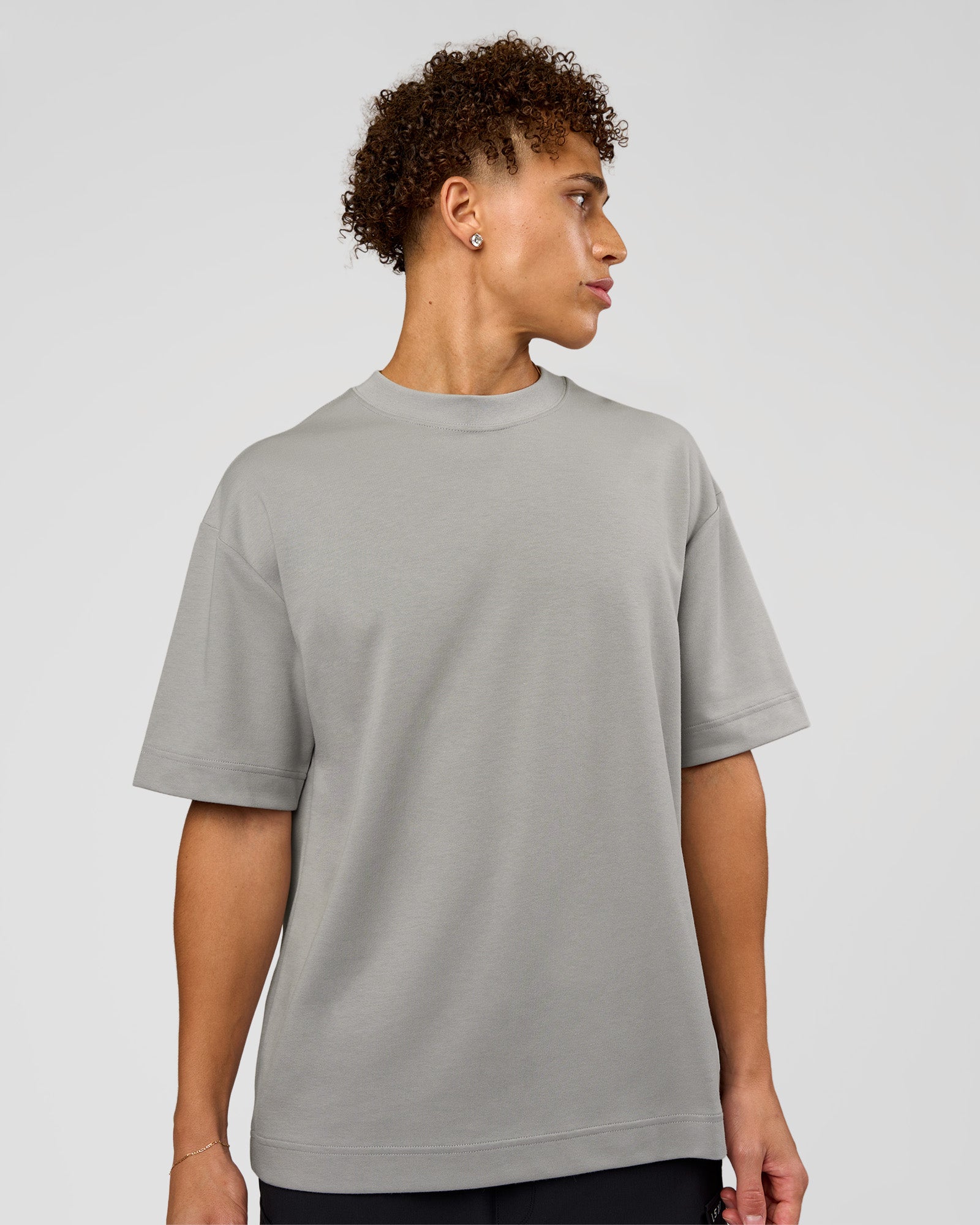 Man wearing AfterDark ZeroCrease Oversized Tee - Alloy | Model:Leandro | Size:M