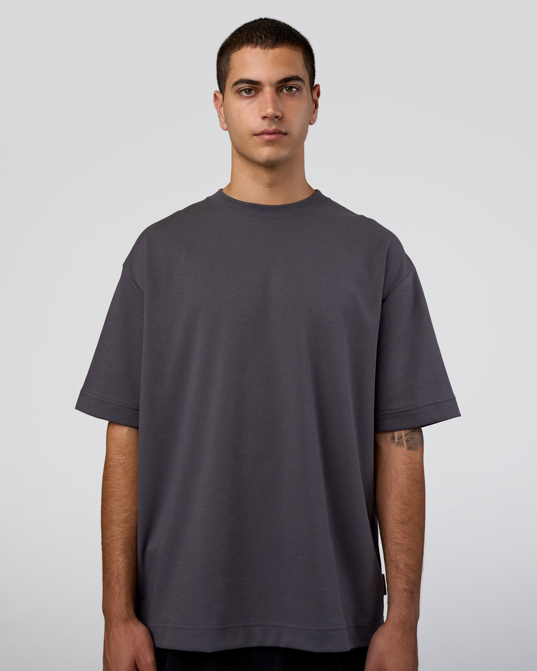 Man wearing AfterDark ZeroCrease Oversized Tee - Dark Storm | Model:Zoran | Size:M
