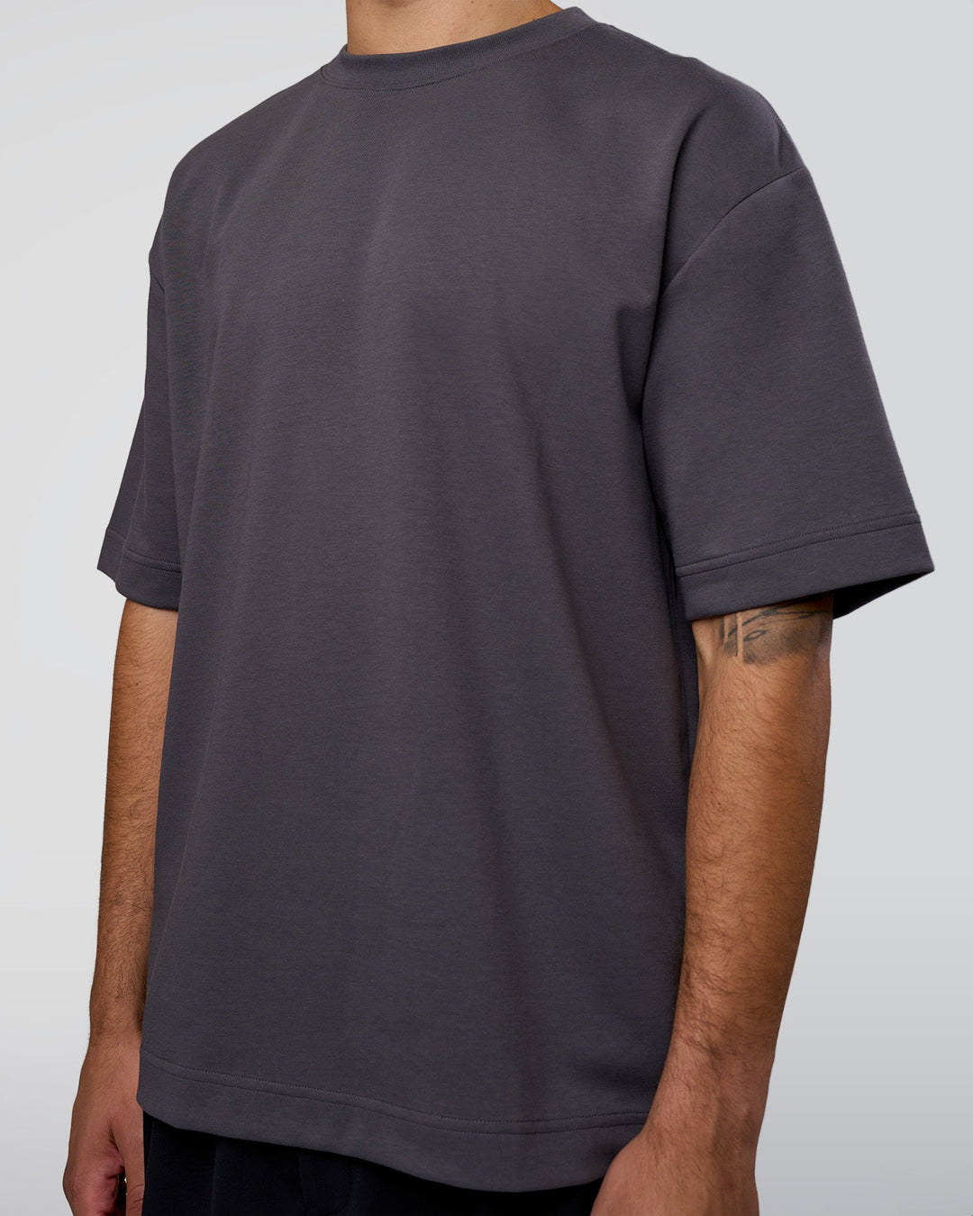 Man wearing AfterDark ZeroCrease Oversized Tee - Dark Storm | Model:Zoran | Size:M