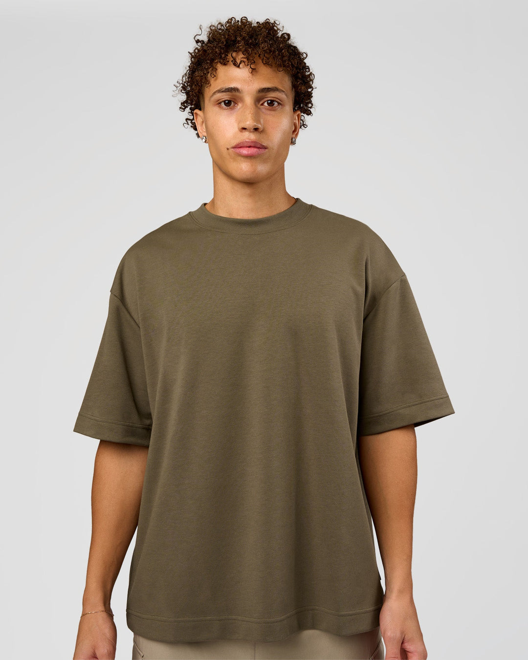 Man wearing AfterDark ZeroCrease Oversized Tee - Walnut Grey | Model:Leandro | Size:M