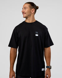 Man wearing Archive FLXCotton Oversized Tee - Black-Open Air | Model:Jaiden | Size:M