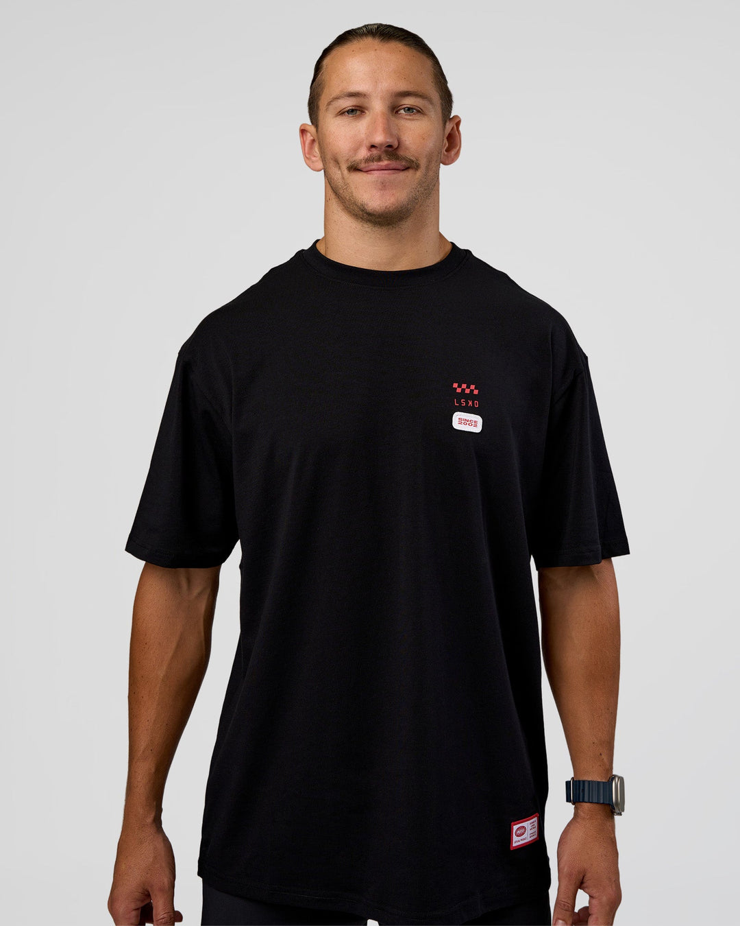 Man wearing Archive FLXCotton Oversized Tee - Black-Scarlet | Model:Jaiden | Size:M