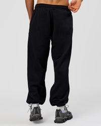 Man wearing Base Baggy Cuffed Track Pant - Black | Model:Albert | Size:M |
