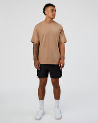 Man wearing Base FLXCotton Tee Oversized - Warm Smoke | Model:Daarian | Size:M