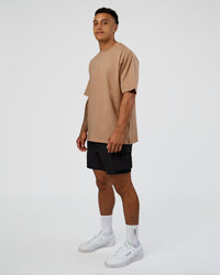 Man wearing Base FLXCotton Tee Oversized - Warm Smoke | Model:Daarian | Size:M