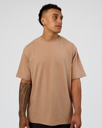 Man wearing Base FLXCotton Tee Oversized - Warm Smoke | Model:Daarian | Size:M