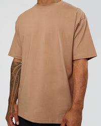 Man wearing Base FLXCotton Tee Oversized - Warm Smoke | Model:Daarian | Size:M