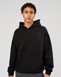 Man wearing Base Oversized Hoodie - Black | Model:Leandro | Size:M |