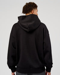 Man wearing Base Oversized Hoodie - Black | Model:Leandro | Size:M |