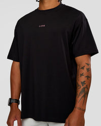 Man wearing CFT BNE 26 FLXCotton Oversized Tee in Black | Model:Malebo | Size:M