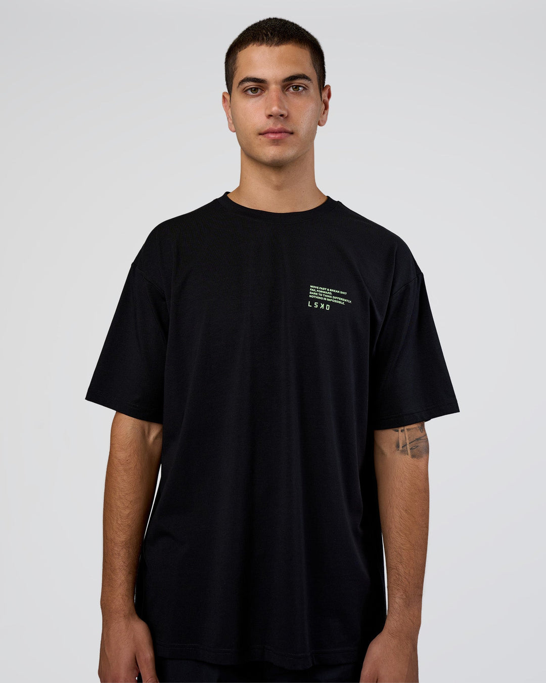 Man wearing Coffee Run FLXCotton Oversized Tee - Black-Solar Lime | Model:Zoran | Size:M