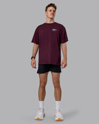 Man wearing Coffee Run FLXCotton Oversized Tee - Cherry Lacquer-Black | Model:Cameron | Size:M