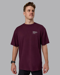 Man wearing Coffee Run FLXCotton Oversized Tee - Cherry Lacquer-Black | Model:Cameron | Size:M