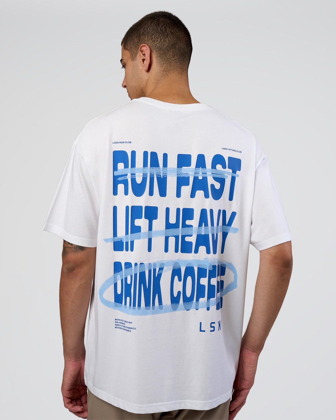 Man wearing Coffee Run FLXCotton Oversized Tee - White-Electric Indigo | Model:Zoran | Size:L