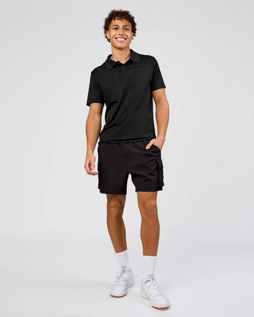 Man wearing Drive Seamless Polo - Black | Model:Leandro | Size:M