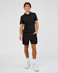 Man wearing Drive Seamless Polo - Black | Model:Leandro | Size:M