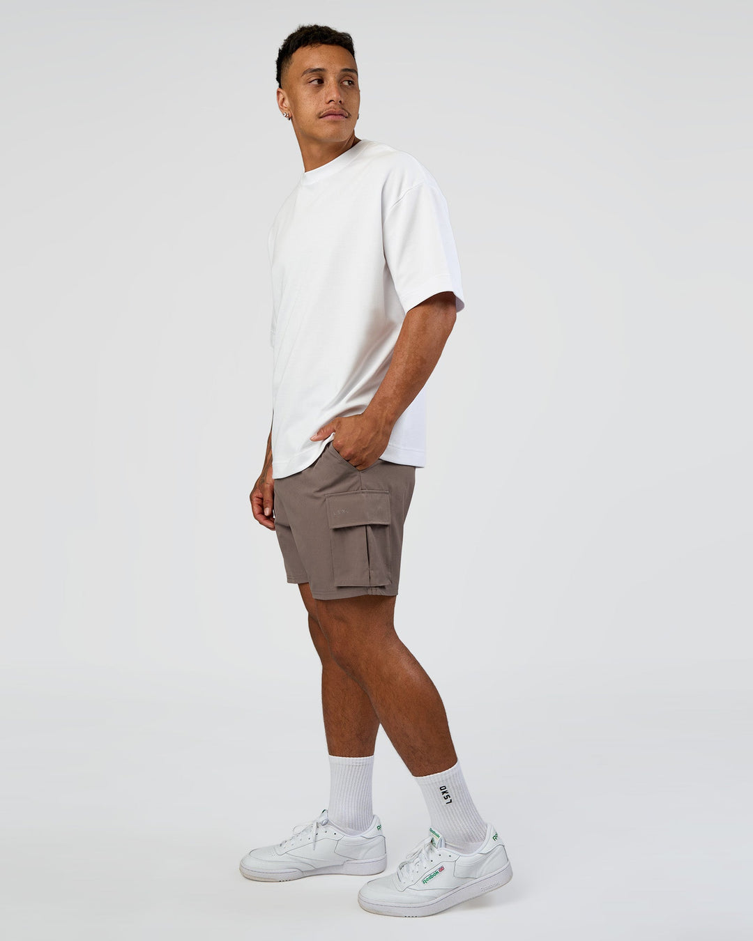 Man wearing Energy Stretch 6" Performance Cargo Short - Iron | Model:Daarian | Size:M