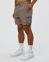 Man wearing Energy Stretch 6" Performance Cargo Short - Iron | Model:Daarian | Size:M