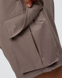 Man wearing Energy Stretch 6" Performance Cargo Short - Iron | Model:Daarian | Size:M