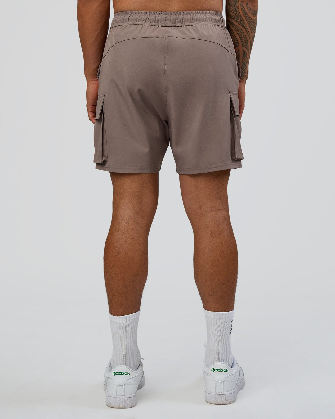 Man wearing Energy Stretch 6" Performance Cargo Short - Iron | Model:Daarian | Size:M