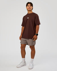 Man wearing Everyday Elevation FLXCotton Oversized Tee - Hot Chocolate-Off White | Model:George | Size:M