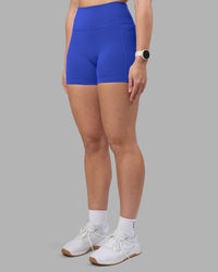 Woman wearing Fusion Ultra High-Rise 4" Short Pockets - Power Cobalt | Set:true | Angle:side | Model:Amy | Size:M