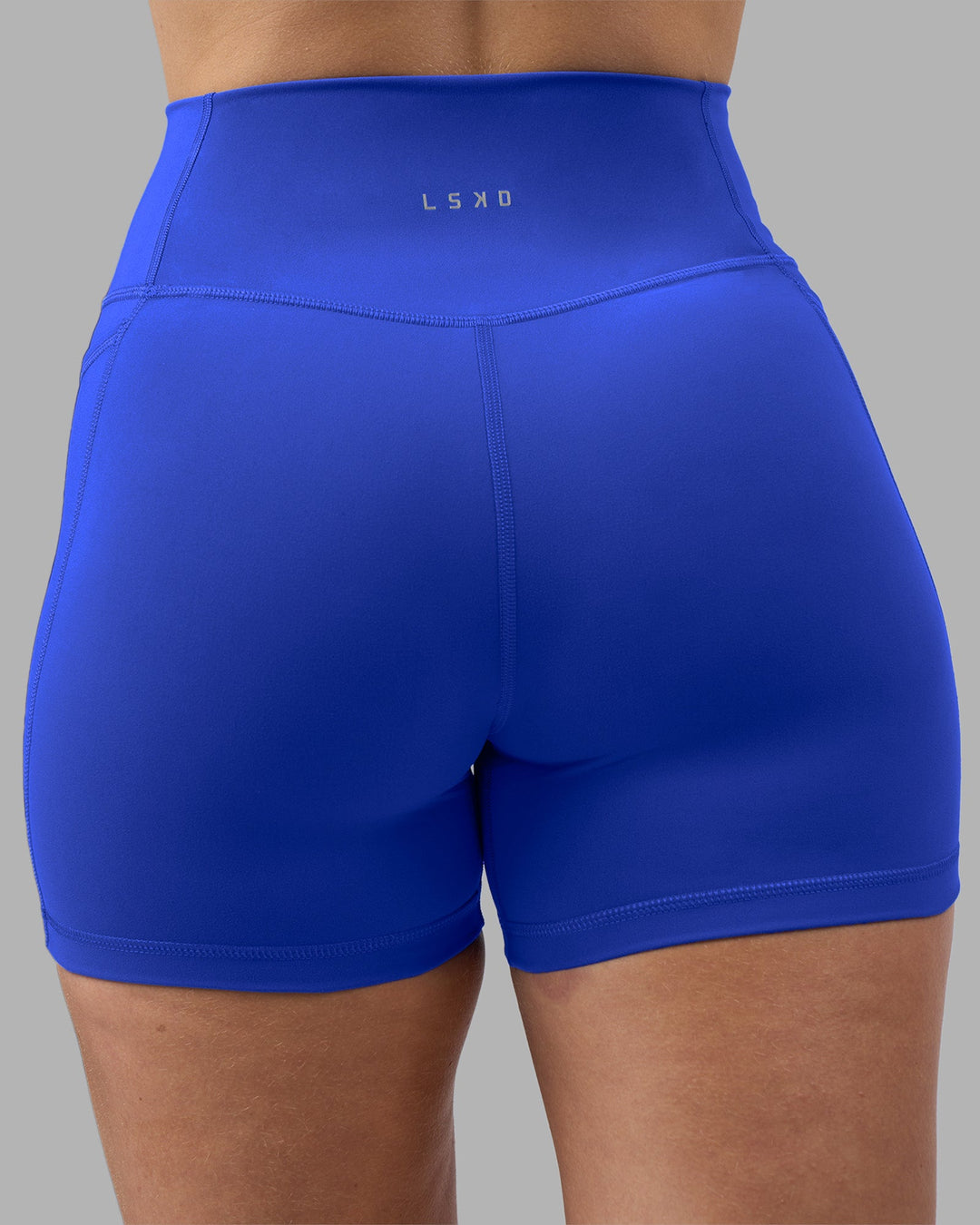Woman wearing Fusion Ultra High-Rise 4&quot; Short Pockets - Power Cobalt | Model:Amy | Size:M