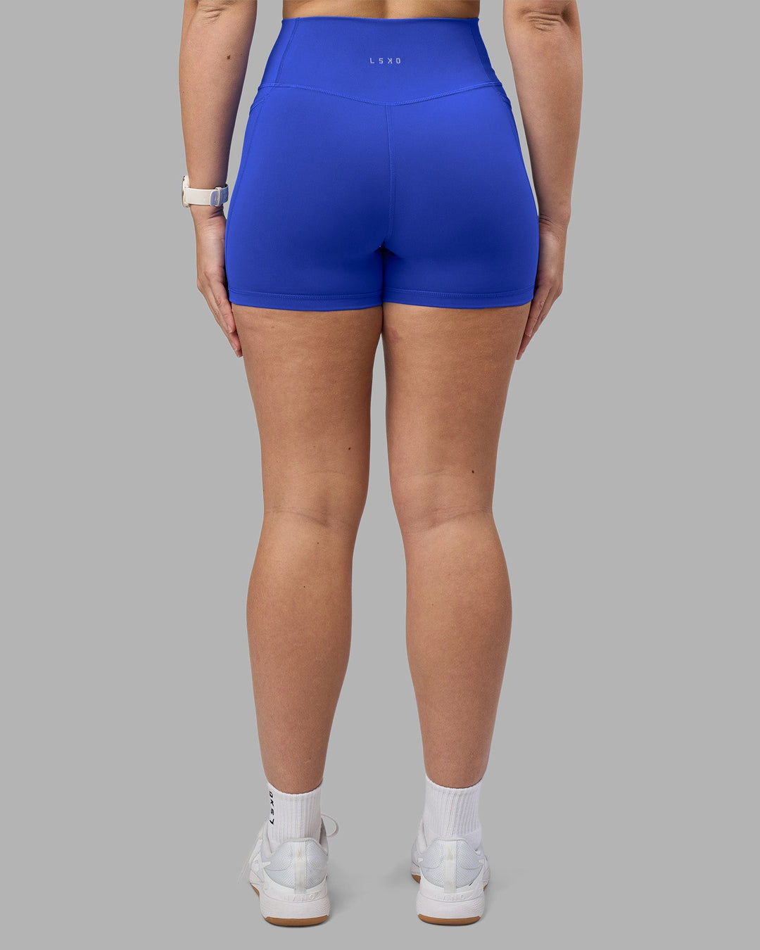 Woman wearing Fusion Ultra High-Rise 4&quot; Short Pockets - Power Cobalt | Model:Amy | Size:M