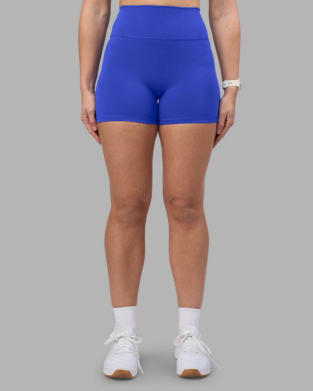 Woman wearing Fusion Ultra High-Rise 4&quot; Short - Power Cobalt | Model:Amy | Size:M