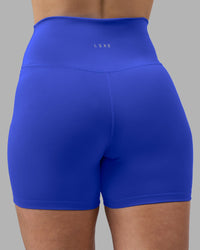 Woman wearing Fusion Ultra High-Rise 4" Short - Power Cobalt | Model:Amy | Size:M