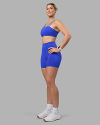 Woman wearing Fusion Ultra High-Rise 6" Short Pockets - Power Cobalt | Model:Amy | Size:M