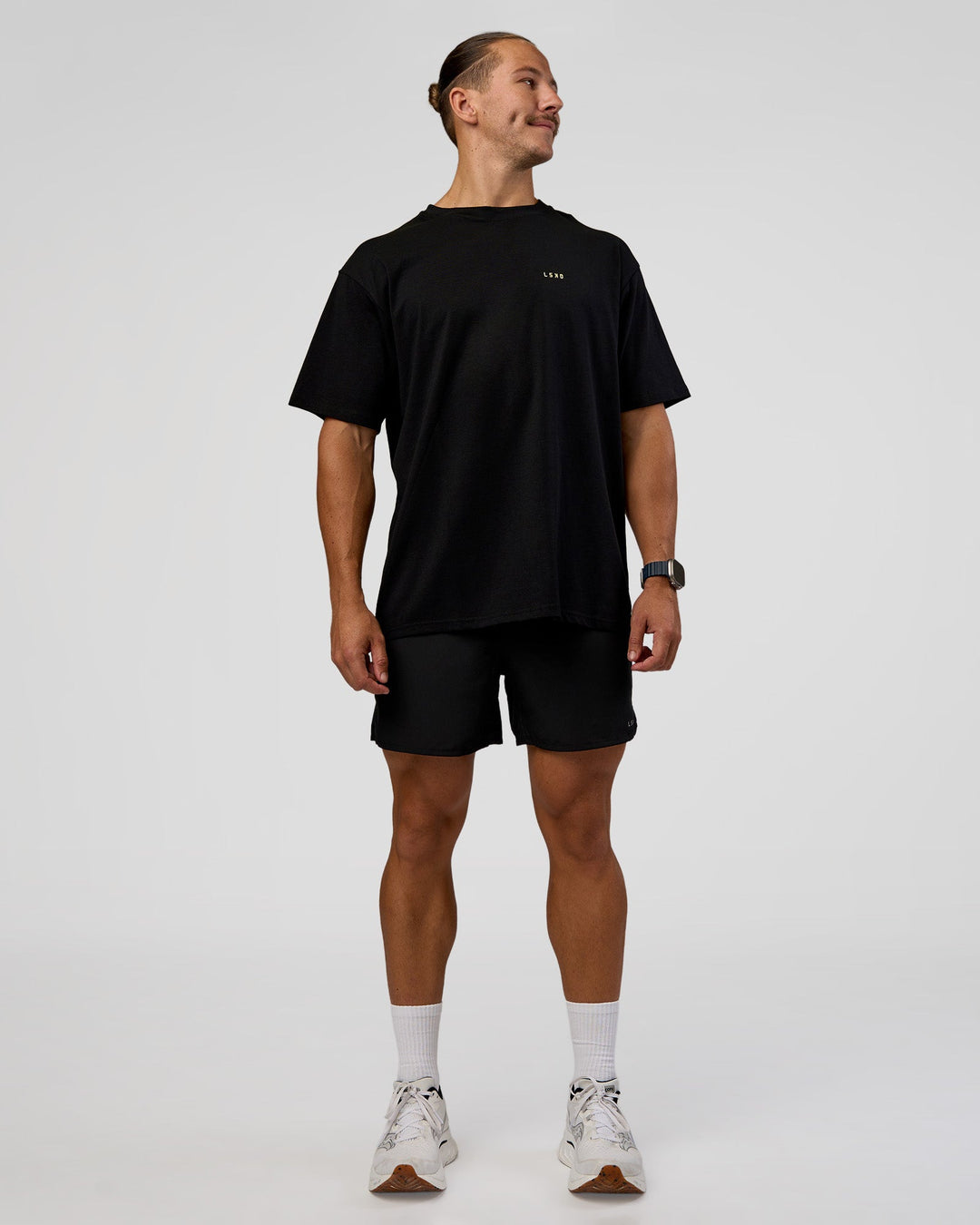 Man wearing High Run FLXCotton Oversized Tee - Black-Yellow Fizz | Model:Jaiden | Size:M