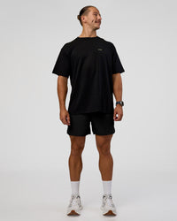 Man wearing High Run FLXCotton Oversized Tee - Black-Yellow Fizz | Model:Jaiden | Size:M