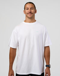 Man wearing High Run FLXCotton Oversized Tee - White-Jelly Mint | Model:Jaiden | Size:M
